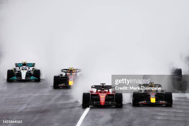 Max Verstappen of the Netherlands driving the Oracle Red Bull Racing RB18 and Charles Leclerc of Monaco driving the Ferrari F1-75 battle for track...