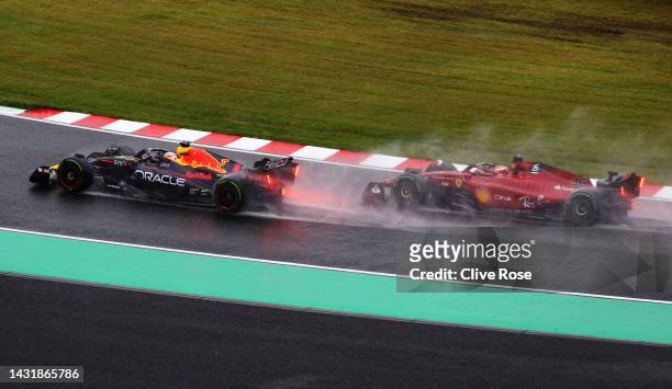 Max Verstappen of the Netherlands driving the Oracle Red Bull Racing RB18 leads Charles Leclerc of Monaco driving the Ferrari F1-75 on lap one during...