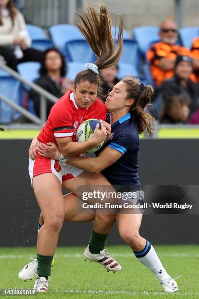 Kayleigh Powell of Wales is tackled by Rhona Lloyd of Scotland during the Pool A Rugby World Cup 2021 New Zealand match match between Wales and...