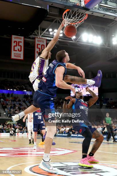 Xavier Cooks of the Kings dunks against Isaac Humphries of United during the round two NBL match between Melbourne United and Sydney Kings at John...