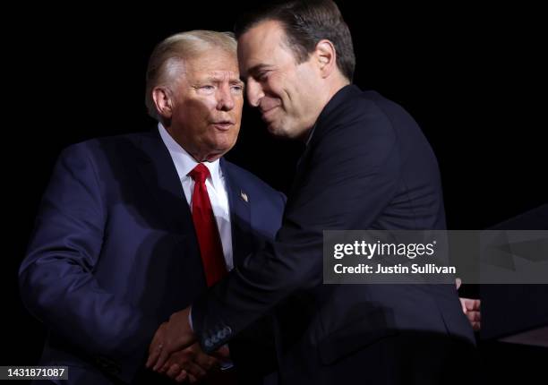 Nevada republican U.S. Senate candidate Adam Laxalt greets former U.S. President Donald Trump on stage during a campaign rally at Minden-Tahoe...