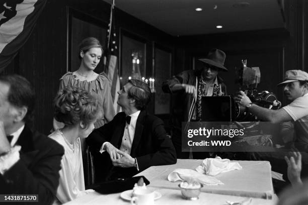 Barbara Harris, Meryl Streep, Alan Alda, director Jerry Schatzberg, and an unidentified crew member prepare for filming during production of "The...