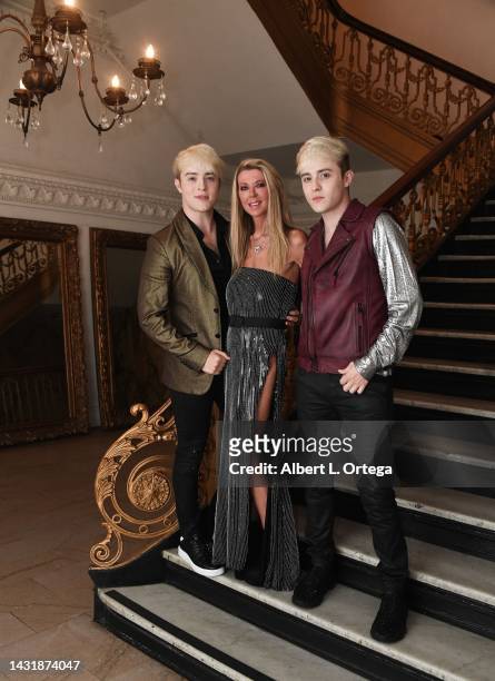 Tara Reid and John Grimes and Edward Grimes of Jedward pose at The Fashion Life Tour during Los Angeles Fashion Week at Alexandria Hotel on October...