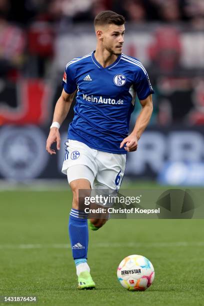 Tom Krauß of Schalke runs with the ball during the Bundesliga match between Bayer 04 Leverkusen and FC Schalke 04 at BayArena on October 08, 2022 in...