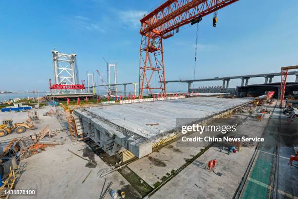 The 155th box girder is loaded to the crane "Tianyi" at the construction site of the Shenzhen-Zhongshan bridge, a part of Shenzhen-Zhongshan Link of...