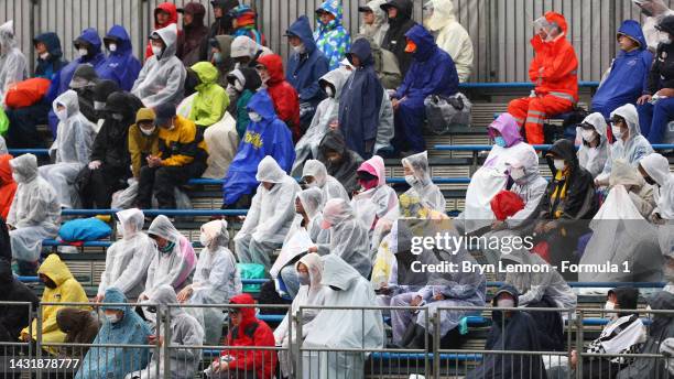 Fans wear ponchos in the rain during the F1 Grand Prix of Japan at Suzuka International Racing Course on October 09, 2022 in Suzuka, Japan.