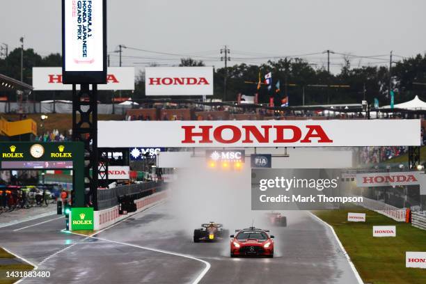 The FIA Safety Car leads the field at the restart after a red flag delay during the F1 Grand Prix of Japan at Suzuka International Racing Course on...