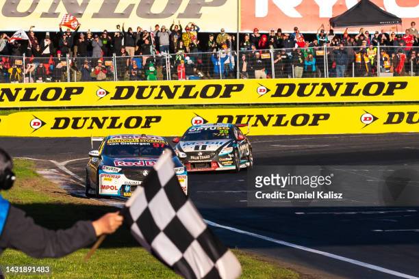 Shane van Gisbergen driver of the Red Bull Ampol Holden Commodore ZB takes the chequered flag to win the Bathurst 1000, which is race 30 of 2022...