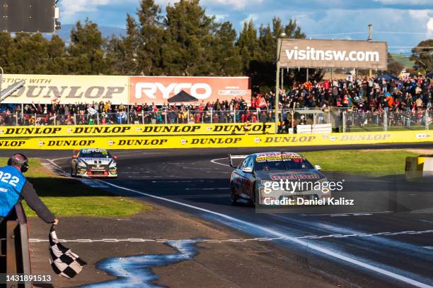 Shane van Gisbergen driver of the Red Bull Ampol Holden Commodore ZB takes the chequered flag to win the Bathurst 1000, which is race 30 of 2022...