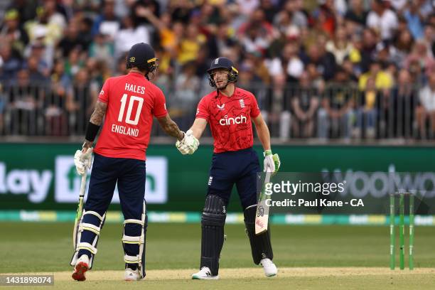 Jos Buttler of England celebrates his half century with Alex Hales during game one of the T20 International series between Australia and England at...