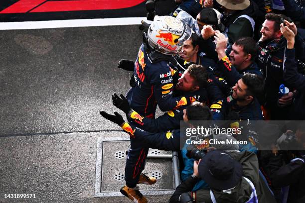 Race winner and 2022 F1 World Drivers Champion Max Verstappen of Netherlands and Oracle Red Bull Racing celebrates with his team in parc ferme during...