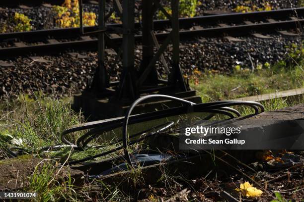 Newly-laid cable lies next to railway tracks at the spot in Hohenschoenhausen district where the day before technicians repaired a section of fibre...