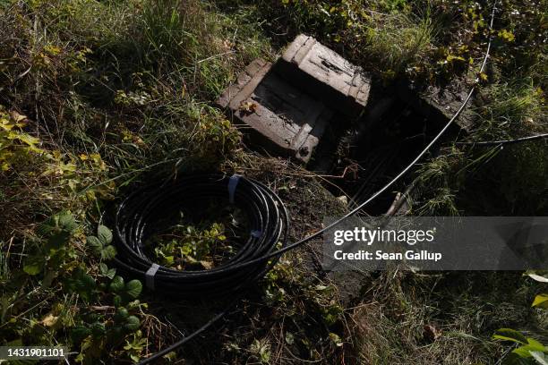 Newly-laid cable lies next to railway tracks at the spot in Hohenschoenhausen district where the day before technicians repaired a section of fibre...