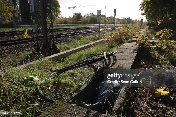 Newly-laid cable lies next to railway tracks at the spot in Hohenschoenhausen district where the day before technicians repaired a section of fibre...