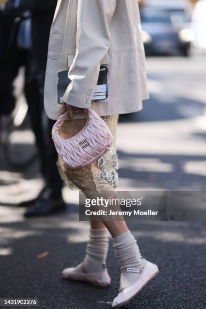 Brittany Xavier seen wearing a beige blazer, glitter skirt, socks and Miu Miu ballerinas, rose Miu Miu leather handbag, outside Miu Miu during...