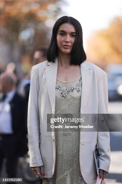 Brittany Xavier seen wearing a beige blazer, glitter skirt, socks and Miu Miu ballerinas, rose Miu Miu leather handbag, outside Miu Miu during...