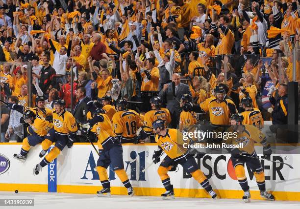 The Nashville Predators bench and fans erupt in celebration as the horn sounds in a 2-1 series clinching win against the Detroit Red Wings in Game...