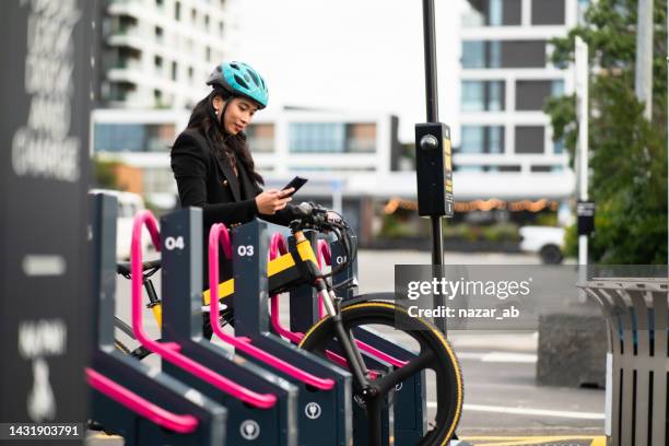 woman in urban station with electric bike and commuting around city. - station stock pictures, royalty-free photos & images