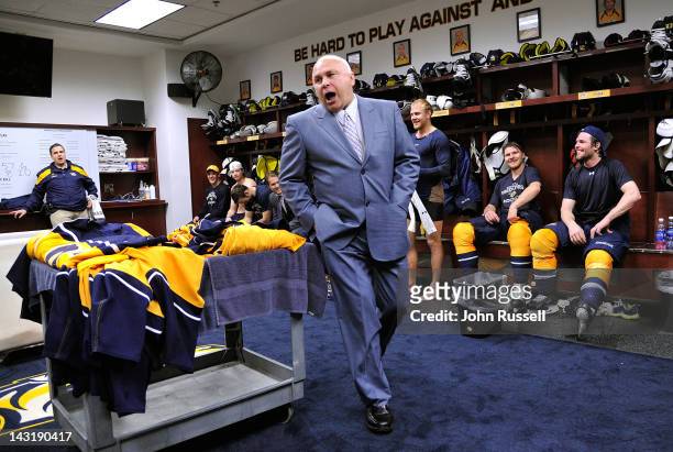 Head coach Barry Trotz of the Nashville Predators congratulates the team in the locker room after the series clinching win against the Detroit Red...