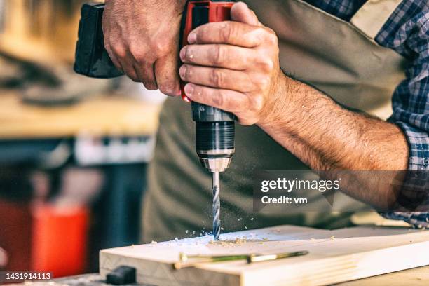 close-up of drilling hole to material - hand tool stock pictures, royalty-free photos & images