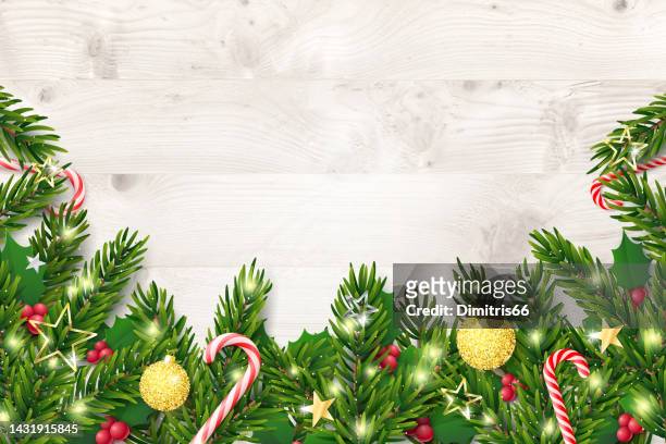 christmas and new year background with fir branches and red berries on rustic wooden planks - christmas table stock illustrations