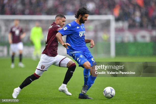 Antonio Sanabria of Torino FC challenges Sebastiano Luperto of Empoli FC during the Serie A match between Torino FC and Empoli FC at Stadio Olimpico...