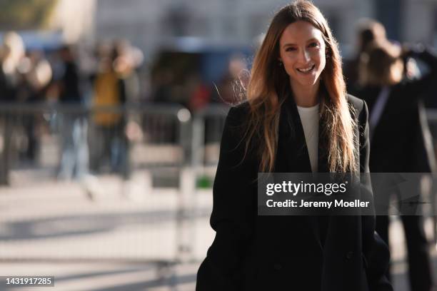 Charlotte Groeneveld alias thefashionguitar seen wearing a Chanel look with an oversize blazer, patterned pants and a white and gold Chanel bag,...