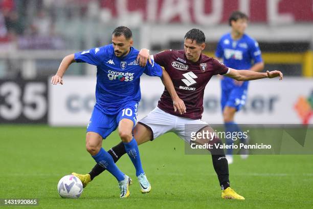 Nedim Bajrami of Empoli FC is challenged by Sasa Lukic of Torino FC during the Serie A match between Torino FC and Empoli FC at Stadio Olimpico di...