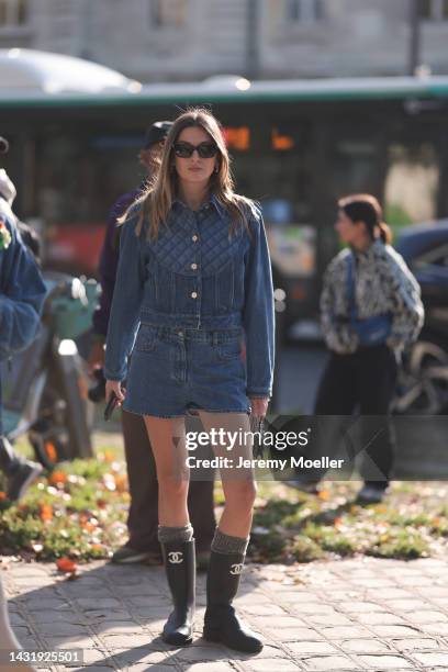 Camille Charriere seen wearing a total denim look with Chanel rubber boots, outside Chanel during Paris Fashion Week on October 04, 2022 in Paris,...