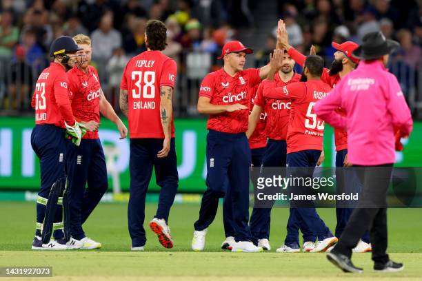 England celebrate a wicket during game one of the T20 International series between Australia and England at Optus Stadium on October 09, 2022 in...