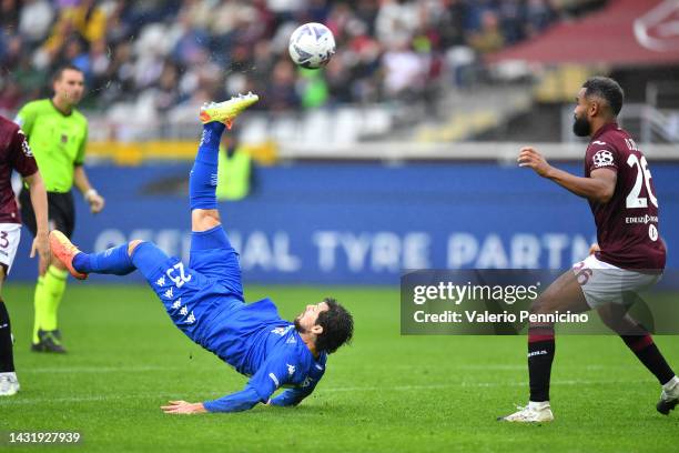 Mattia Destro of Empoli FC scores their side's first goal whilst under pressure from Nikola Vlasic of Torino FC during the Serie A match between...