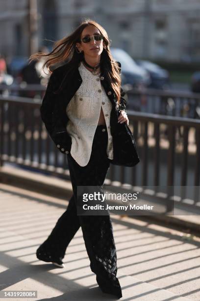 Chloe Harrouche seen wearing a total Chanel look, outside Chanel during Paris Fashion Week on October 04, 2022 in Paris, France.