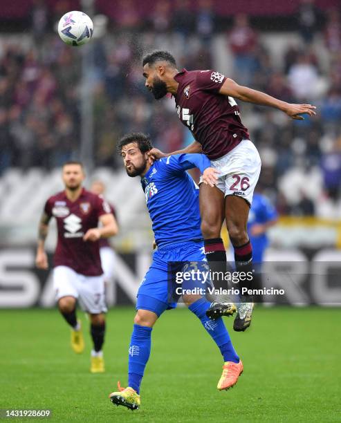 Mattia Destro of Empoli FC contends for the aerial ball with Koffi Djidji of Torino FC during the Serie A match between Torino FC and Empoli FC at...