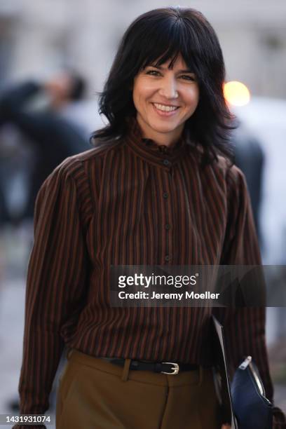 Kerstin Weng seen wearing a striped blouse and green pants, outside Chanel during Paris Fashion Week on October 04, 2022 in Paris, France.