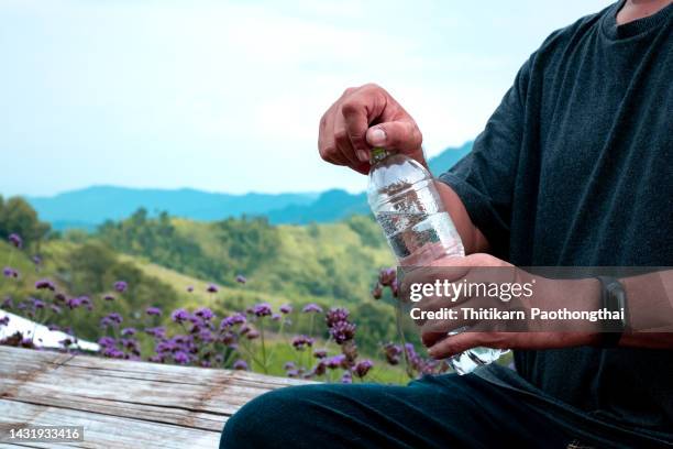 hand hold water with nature landscape - bottles glass top stock pictures, royalty-free photos & images