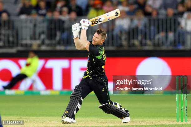 David Warner of Australia smashes the ball for six during game one of the T20 International series between Australia and England at Optus Stadium on...
