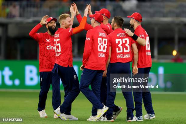 Ben Stokes of England and the England team celebrate a wicket during game one of the T20 International series between Australia and England at Optus...