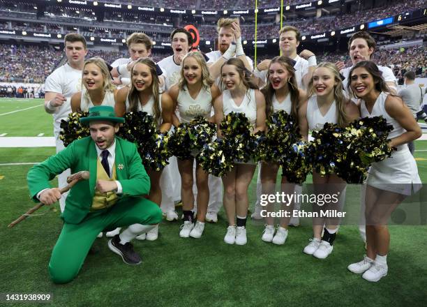Ryan Coury as the leprechaun mascot for the Notre Dame Fighting Irish and cheerleaders pose on a sideline during the Shamrock Series game against the...