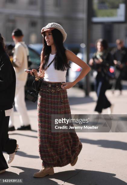 Yoyo Cao seen wearing a Chanel skirt, Chanel loafer and Chanel bag, outside Chanel during Paris Fashion Week on October 04, 2022 in Paris, France.