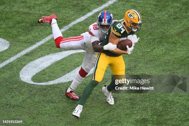 Tyler Davis of the Green Bay Packers is tackled by Tae Crowder of the New York Giants in the first half during the NFL match between New York Giants...