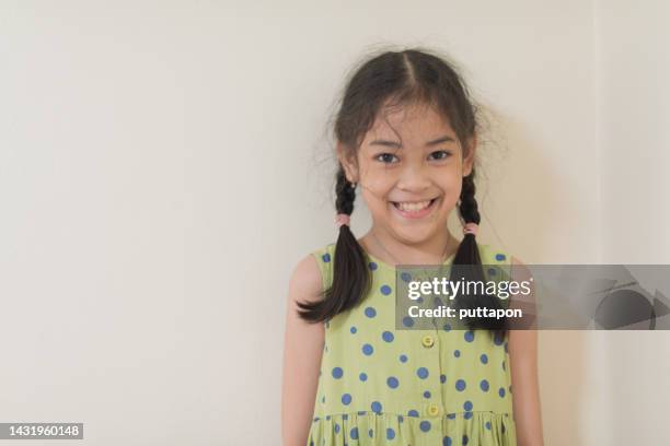 portrait of a young asian girl in various moods and looking at the camera and smile - children only ponytail stock-fotos und bilder