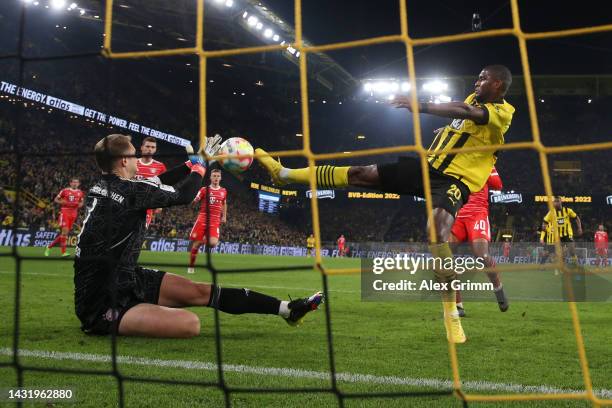 Goalkeeper Manuel Neuer of Bayern Muenchen makes a save against Anthony Modeste of Borussia Dortmund during the Bundesliga match between Borussia...