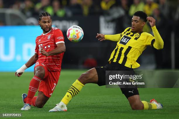 Serge Gnabry of Bayern Muenchen is challenged by Jude Bellingham of Borussia Dortmund during the Bundesliga match between Borussia Dortmund and FC...