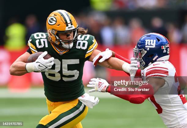 Robert Tonyan of the Green Bay Packers is challenged by Julian Love of the New York Giants in the first half during the NFL match between New York...