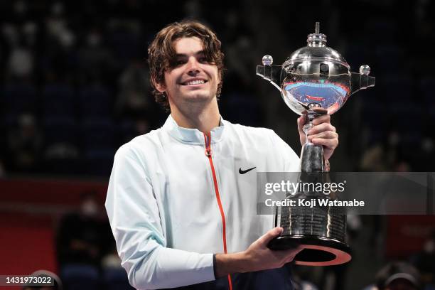 Taylor Fritz of the United States poses with the trophy after defeating Frances Tiafoe of the United States in the singles final game on day seven of...