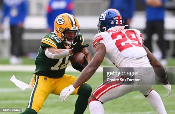 Randall Cobb of the Green Bay Packers runs with the ball from Xavier McKinney of the New York Giants in the second half during the NFL match between...