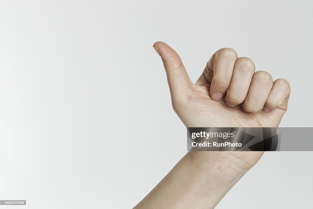 WOMAN MAKING THUMBS UP,hand close-up