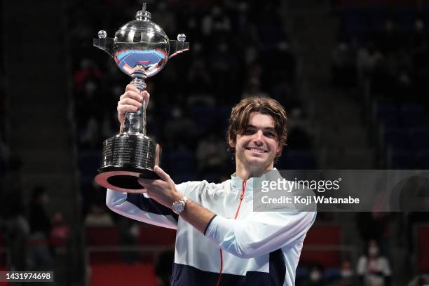 Taylor Fritz of the United States poses with the trophy after defeating Frances Tiafoe of the United States in the singles final game on day seven of...