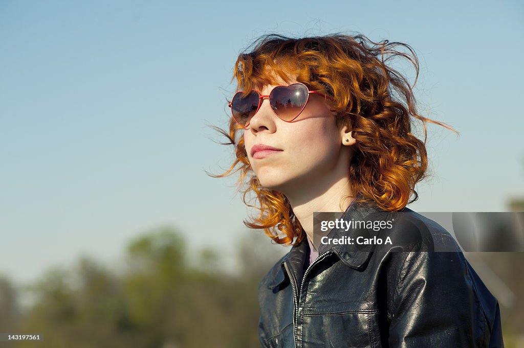 Woman wearing heart shaped sunglasses