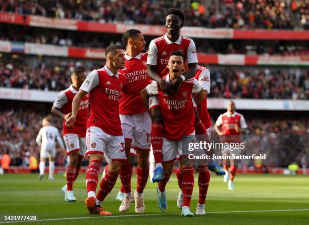 Gabriel Martinelli of Arsenal celebrates with teammates after scoring their team's first goal during the Premier League match between Arsenal FC and...